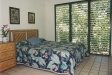 View of Hale Pōhaku guest bedroom with queen bed